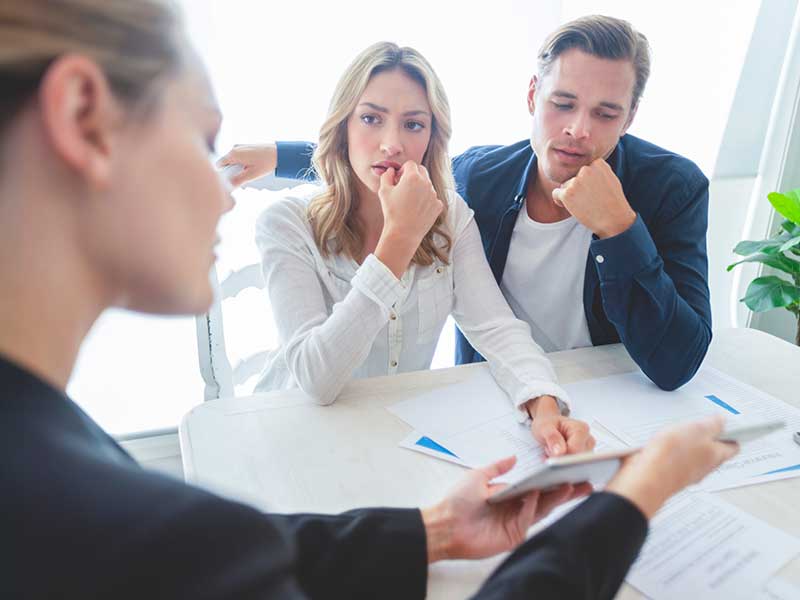 Concerned couple meeting with advisor